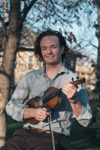 Julian Oliver poses with his fiddle